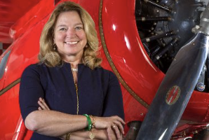 Ellen Stofan standing in front of a red old-timey plane.